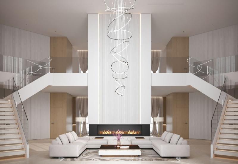 Một cây bàng Singapore lớn đặt cạnh bộ sofa màu be trong phòng khách hiện đại, ánh sáng tự nhiên tràn vào từ cửa sổ lớn, tạo không gian sang trọng và tươi mới.