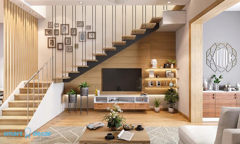 Trang trí góc cầu thang đẹp với tủ sách tích hợp và cây xanh